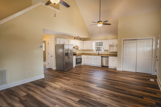 kitchen with sink, dark wood-type flooring, stainless steel appliances, and white cabinets