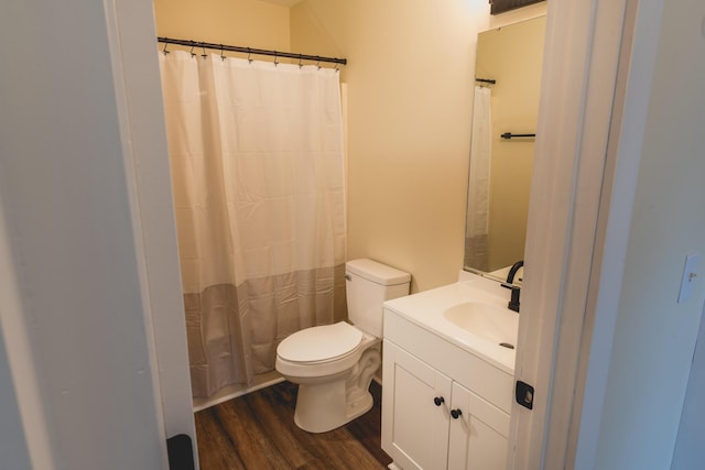 bathroom with hardwood / wood-style flooring, vanity, and toilet