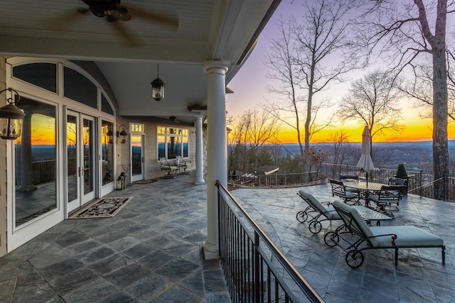 patio terrace at dusk featuring french doors and ceiling fan