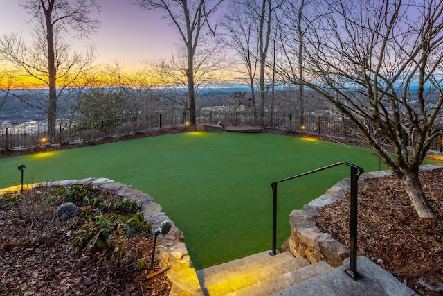 view of yard at dusk