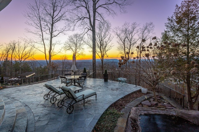 view of patio terrace at dusk