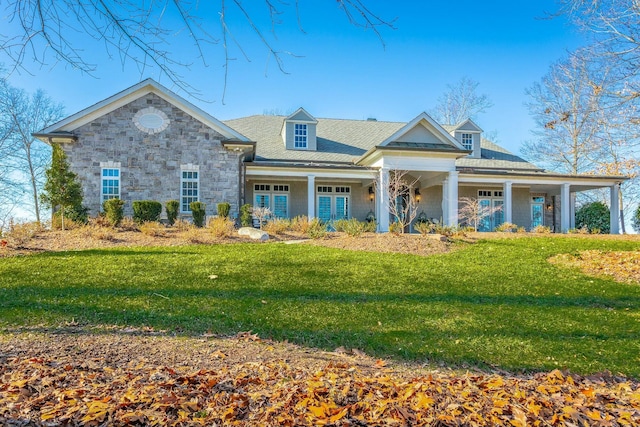 view of front facade with french doors, a porch, and a front lawn