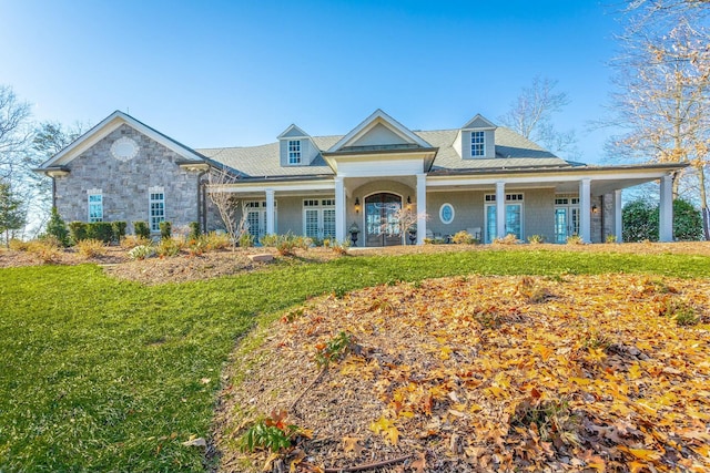 view of front of property featuring french doors, a porch, and a front lawn