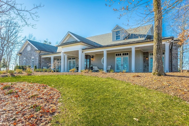 view of front of house featuring a front lawn and french doors