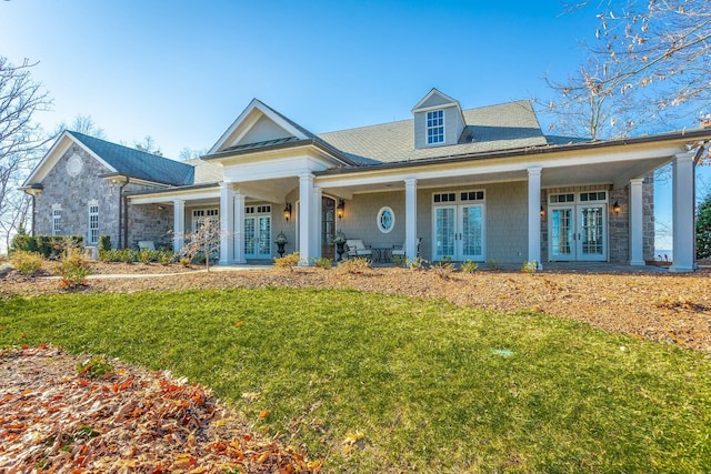 view of front of house featuring a front yard and french doors