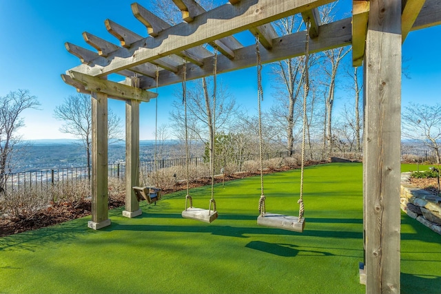 view of property's community with a mountain view and a lawn