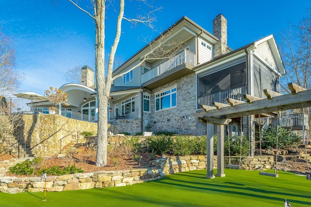 view of community with a pergola and a lawn