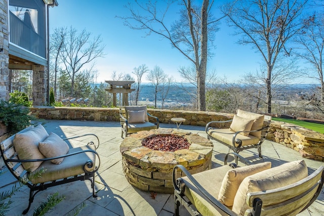 view of patio featuring an outdoor fire pit and a mountain view