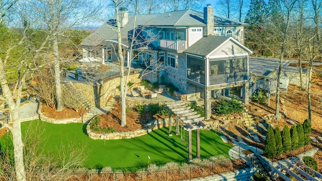 exterior space featuring a balcony and a sunroom