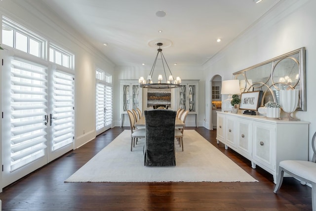 dining area featuring ornamental molding, dark hardwood / wood-style floors, and an inviting chandelier