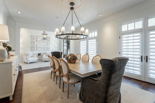 dining area with crown molding, french doors, ornate columns, and hardwood / wood-style flooring