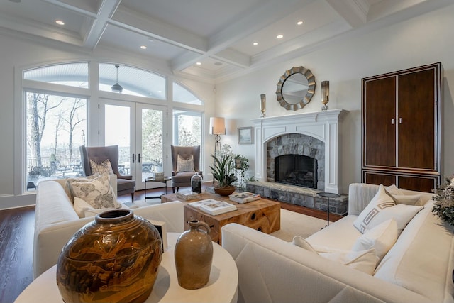 living room with hardwood / wood-style flooring, coffered ceiling, a fireplace, and french doors