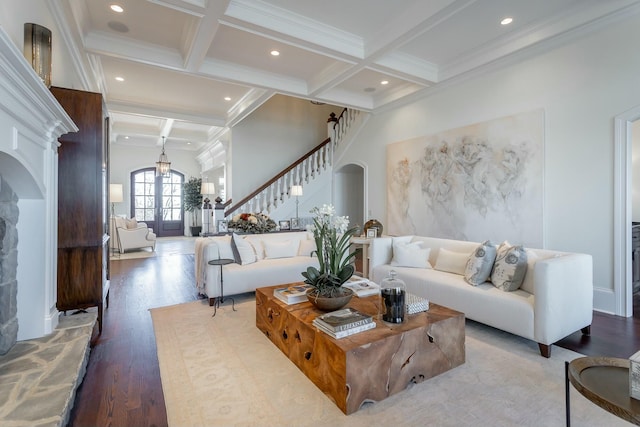 living room with hardwood / wood-style flooring, coffered ceiling, beam ceiling, and crown molding