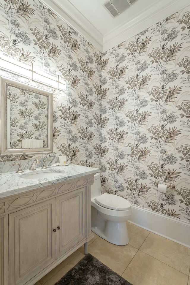 bathroom with vanity, ornamental molding, tile patterned floors, and toilet