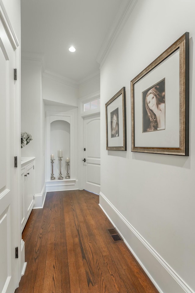 hallway with crown molding and dark hardwood / wood-style floors