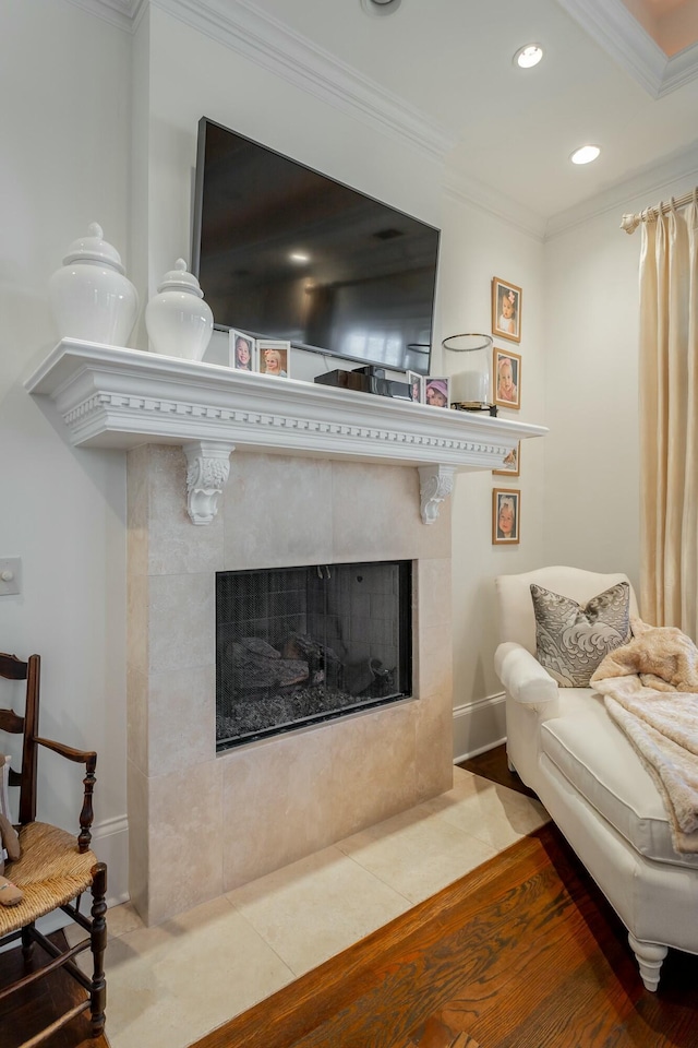 living room with tile patterned flooring, crown molding, and a fireplace