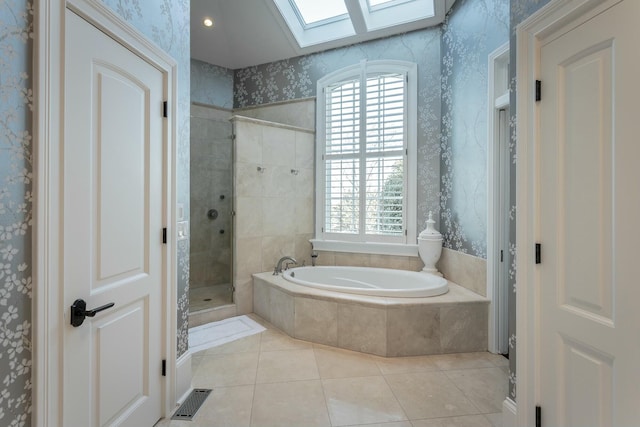 bathroom featuring tile patterned flooring, a skylight, and plus walk in shower