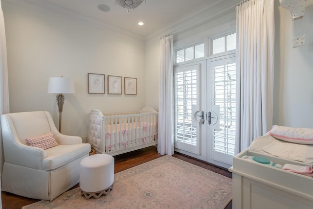 bedroom featuring crown molding, wood-type flooring, and french doors