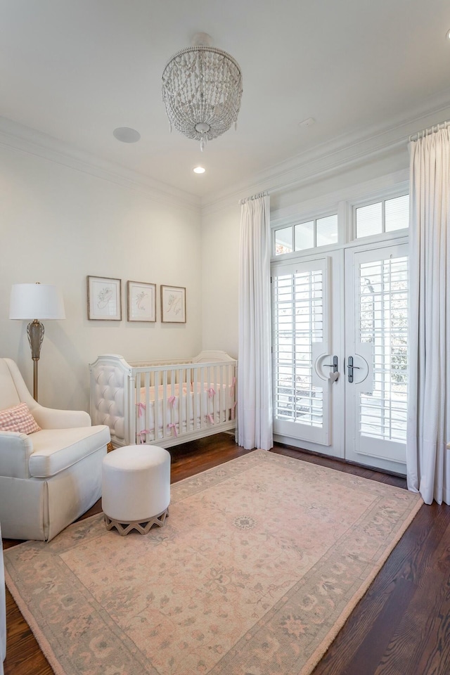 bedroom with crown molding, dark hardwood / wood-style flooring, and french doors