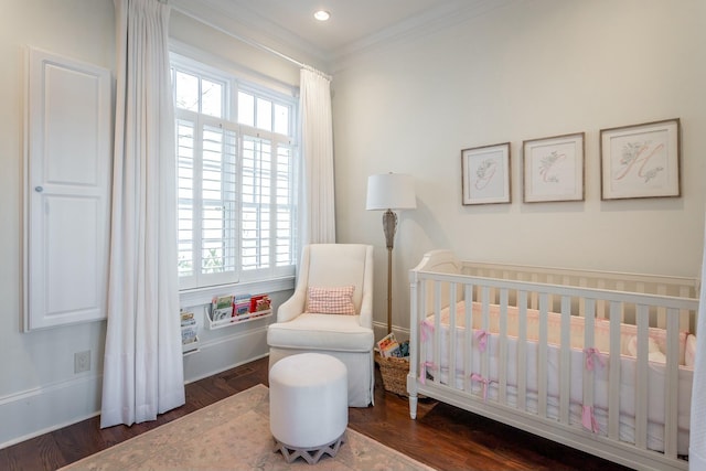 bedroom featuring multiple windows, ornamental molding, dark hardwood / wood-style floors, and a crib