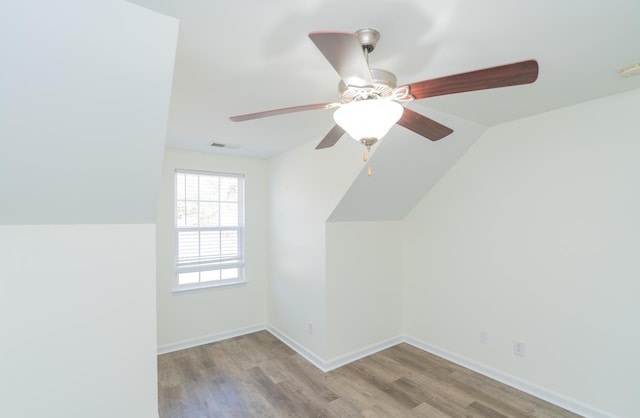 bonus room featuring lofted ceiling and light hardwood / wood-style floors