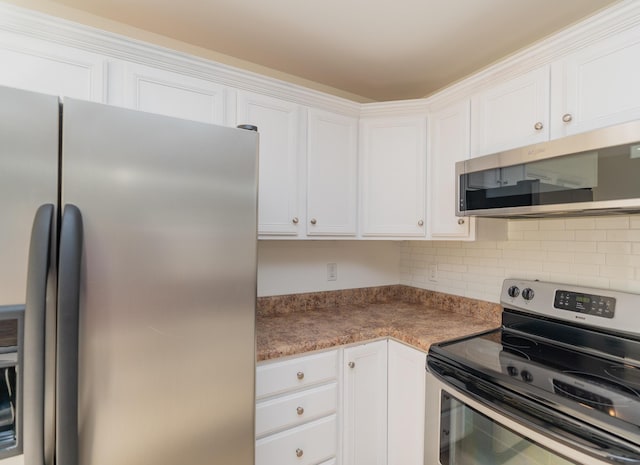 kitchen featuring stainless steel appliances, white cabinetry, and decorative backsplash