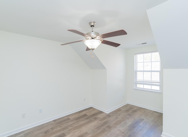 additional living space featuring ceiling fan, lofted ceiling, and light hardwood / wood-style floors