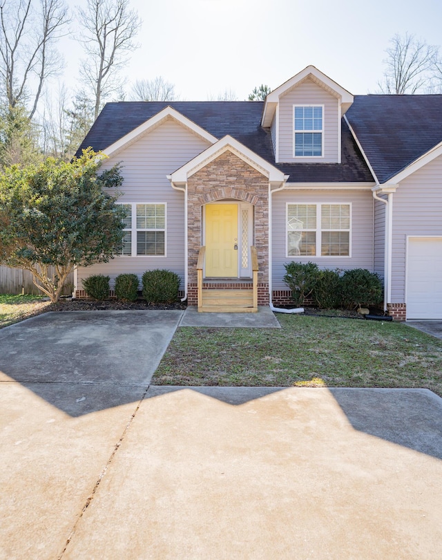 view of front of property featuring a garage and a front lawn