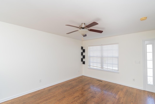 unfurnished room with hardwood / wood-style floors, a healthy amount of sunlight, and ceiling fan