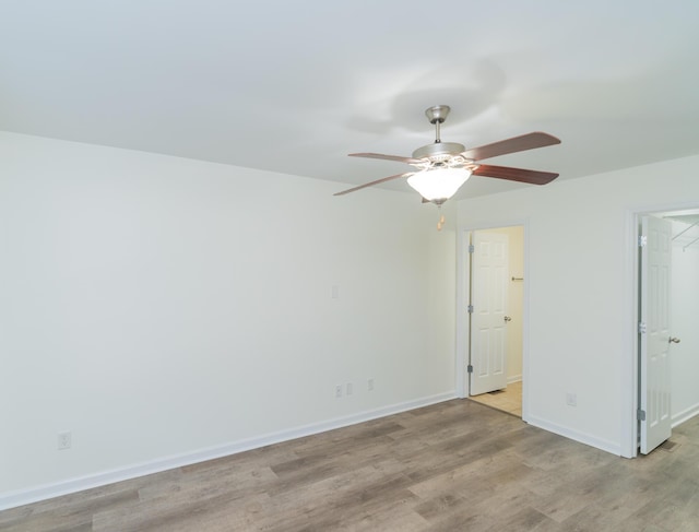 unfurnished room featuring ceiling fan and light wood-type flooring