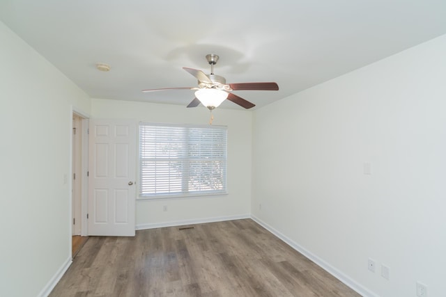 spare room with ceiling fan and light hardwood / wood-style floors