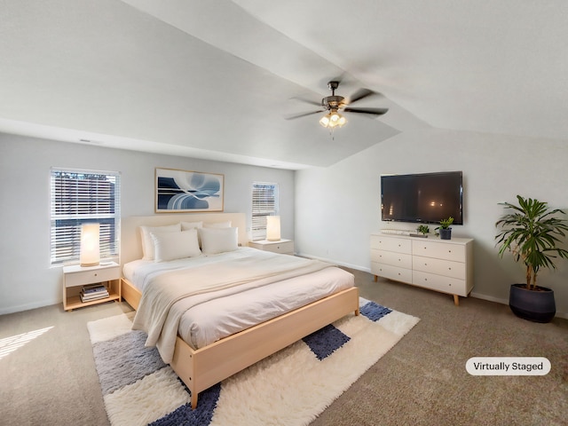 bedroom featuring vaulted ceiling, light colored carpet, and ceiling fan