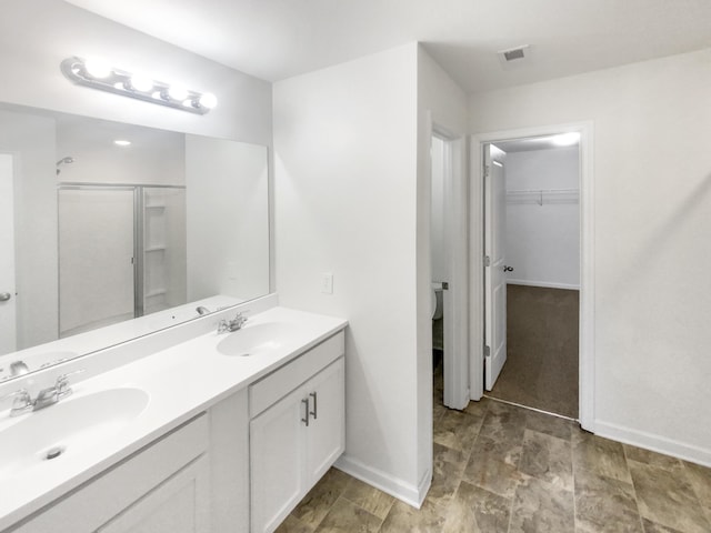 bathroom featuring vanity and an enclosed shower