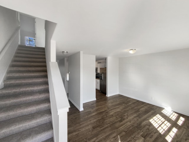 staircase with hardwood / wood-style flooring