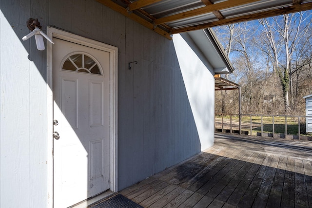 view of exterior entry featuring a wooden deck