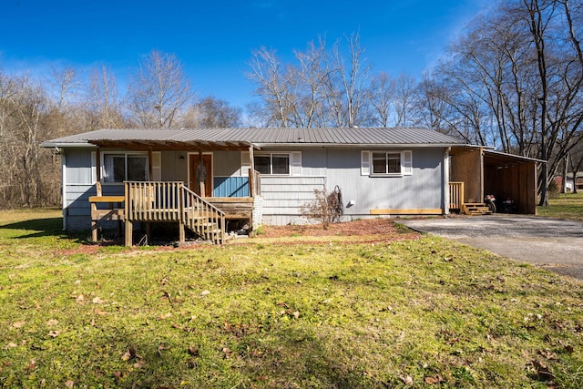 ranch-style house featuring a carport and a front lawn