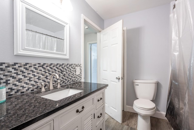 bathroom featuring hardwood / wood-style flooring, vanity, toilet, and decorative backsplash