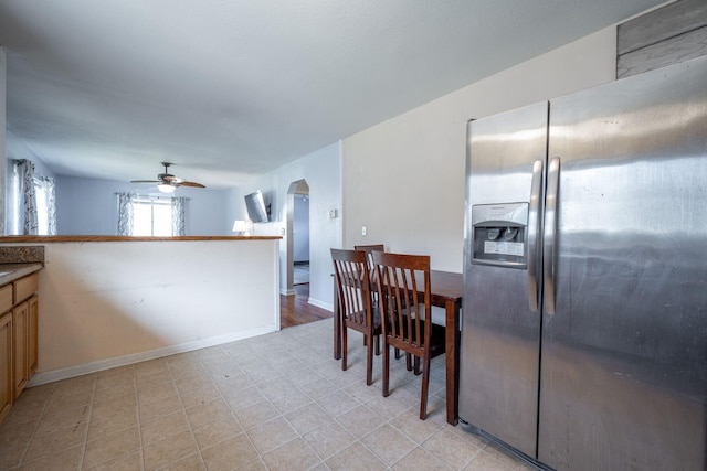 kitchen featuring stainless steel refrigerator with ice dispenser and ceiling fan