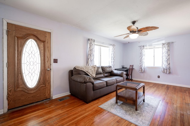 living room featuring hardwood / wood-style flooring and ceiling fan