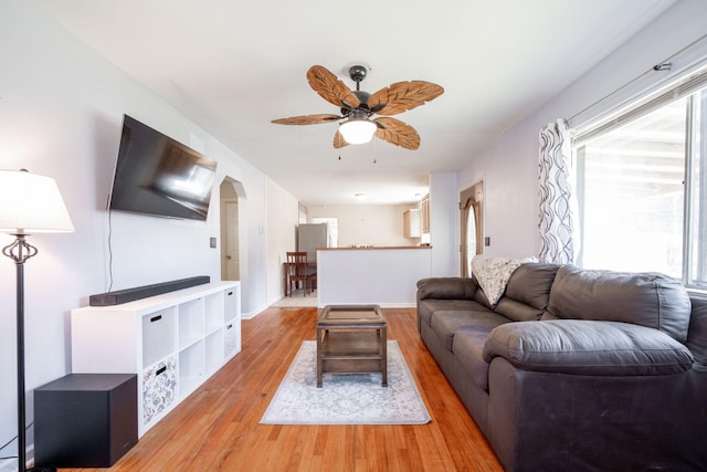 living room with ceiling fan and light wood-type flooring