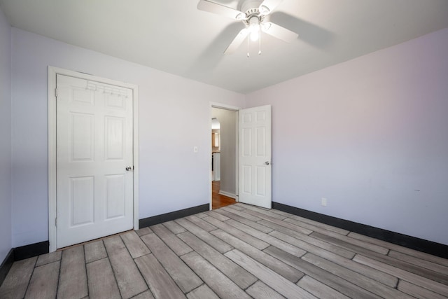 unfurnished bedroom featuring ceiling fan and light wood-type flooring