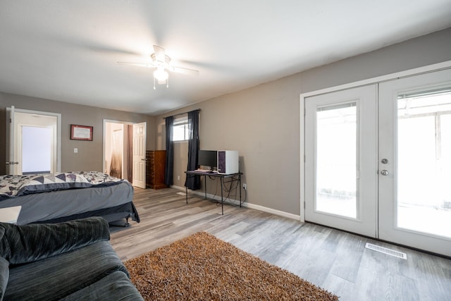 bedroom with french doors, ceiling fan, access to exterior, and light wood-type flooring