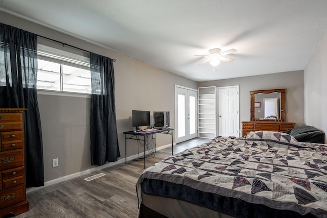 bedroom with wood-type flooring, ceiling fan, and french doors