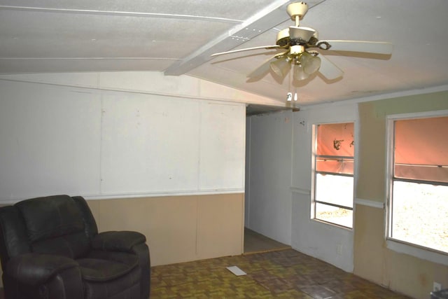 living area with vaulted ceiling with beams and ceiling fan