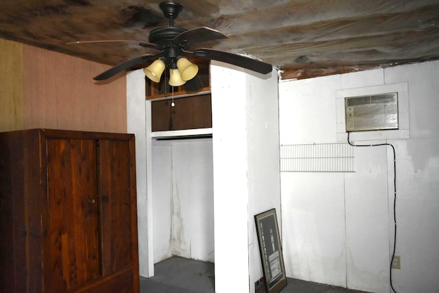 interior space featuring a wall mounted air conditioner and ceiling fan