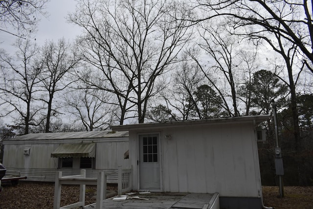 back of property featuring a deck