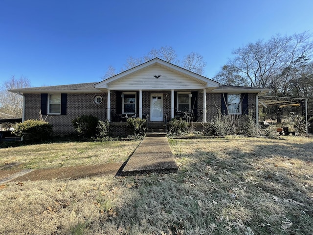 ranch-style house featuring a porch and a front lawn