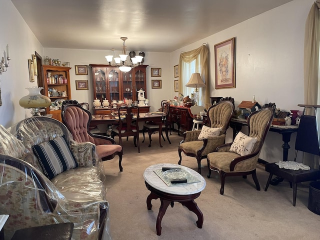 living room with light carpet and an inviting chandelier