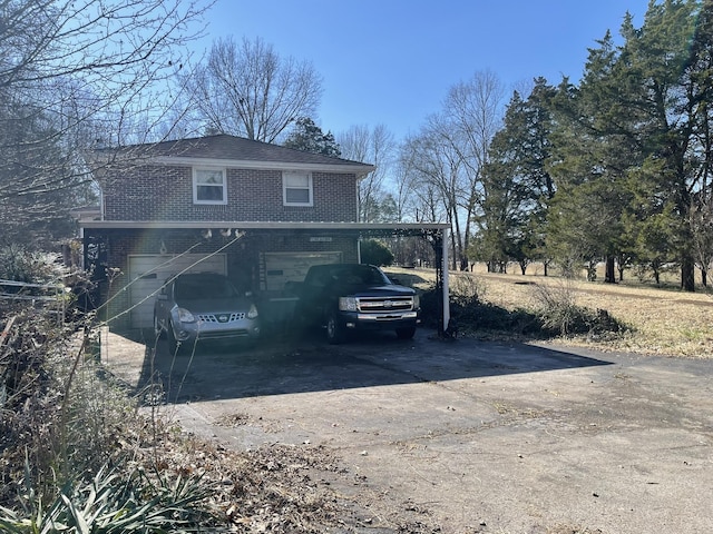 view of side of home with a garage and a carport