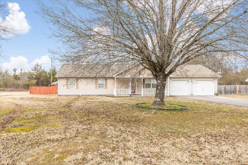 ranch-style house with a garage and a front lawn